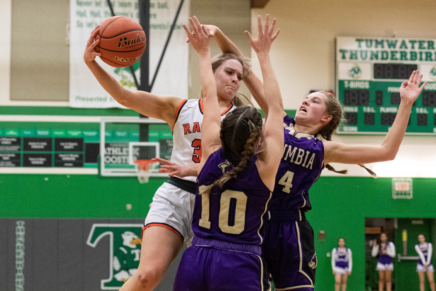 Rainier forward Isabella Holmes passes while facing a double team against Columbia (Burbank) in the regional round of the state tournament at Tumwater Feb. 25.