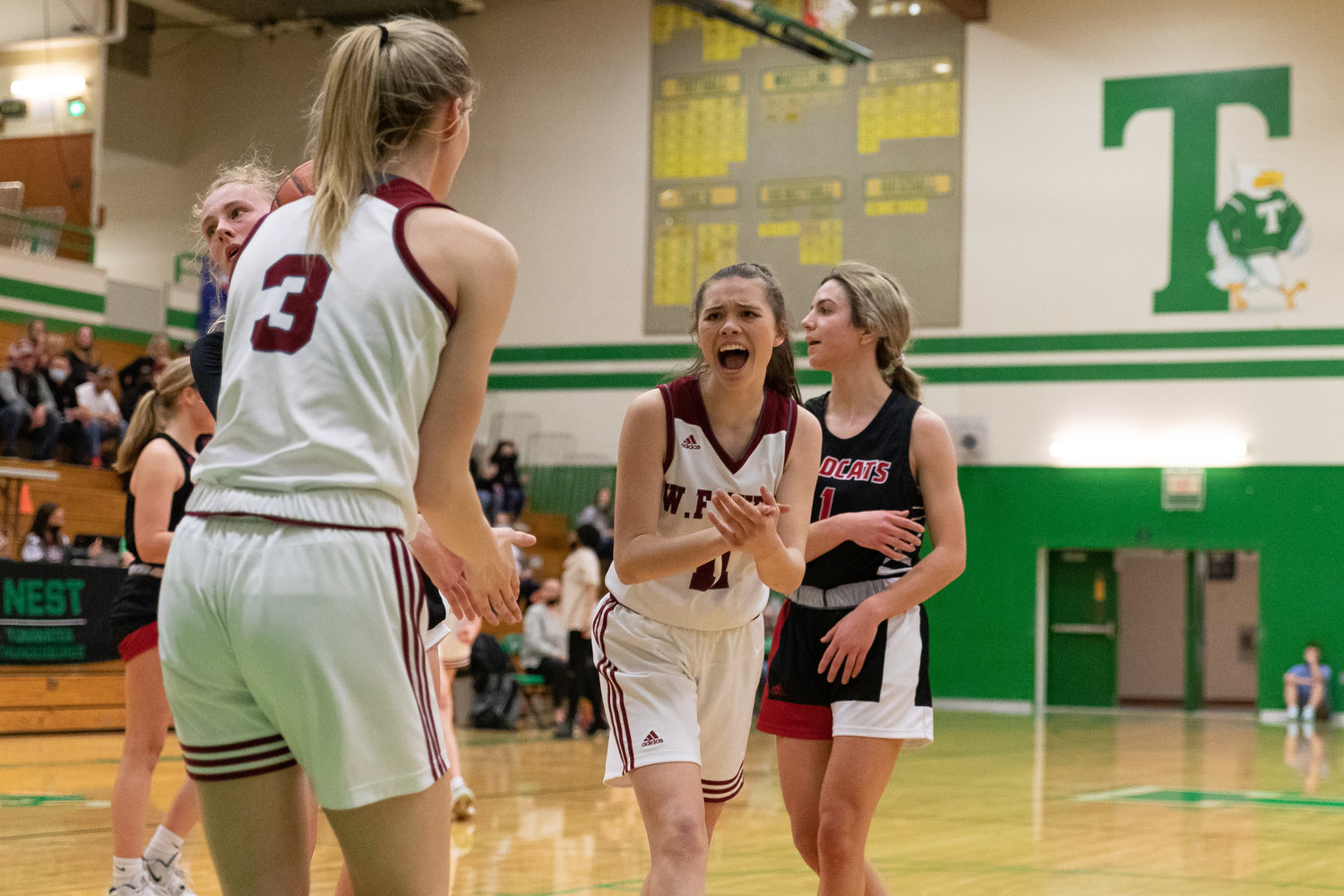 W.F. West's Olivia Remund celebrates Lexi Roberts' and-one against Archbishop Murphy in the regional round of the state tournament at Tumwater Feb. 25.