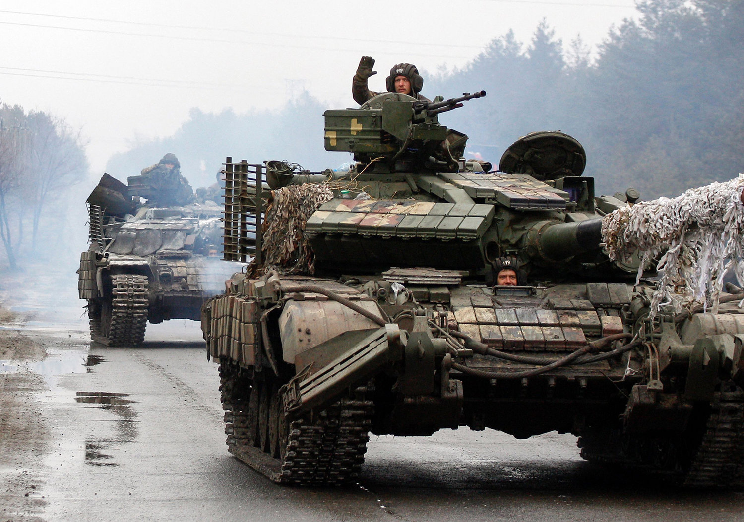 Ukrainian service members ride on tanks toward the front line with Russian forces in the Luhansk region of Ukraine on Feb. 25, 2022. (Anatolii Stepanov/AFP via Getty Images/TNS)