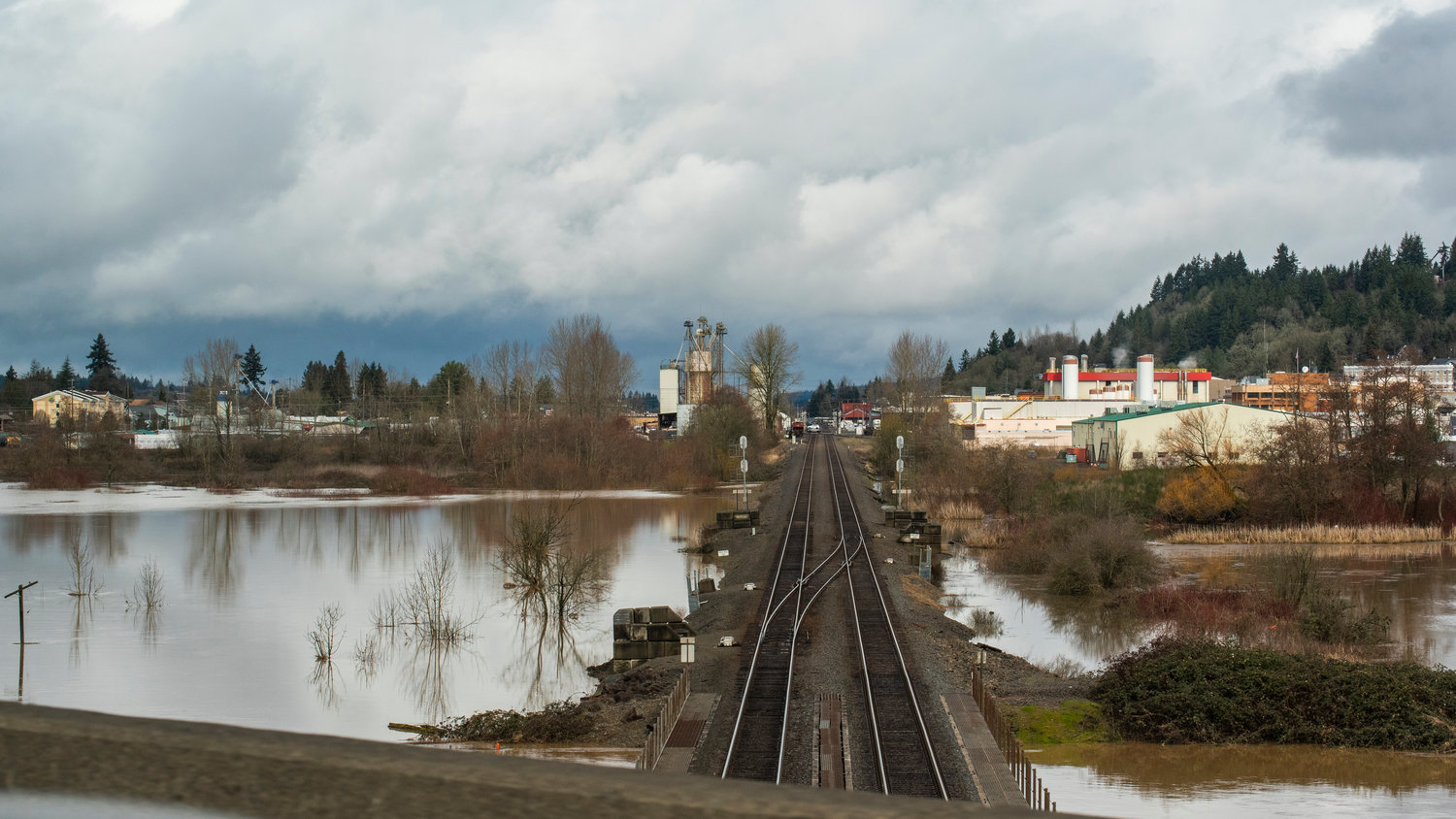Water surrounds train tracks in Chehalis as clouds shift above Tuesday morning.