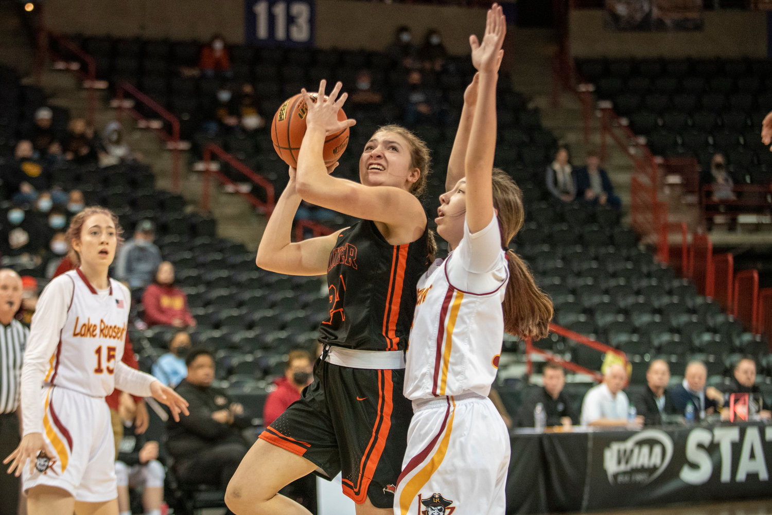 Rainier’s Bryn Beckman (24) drives for a shot against Lake Roosevelt in the opening round of the 2B state tournament Wednesday morning at the Spokane Arena.