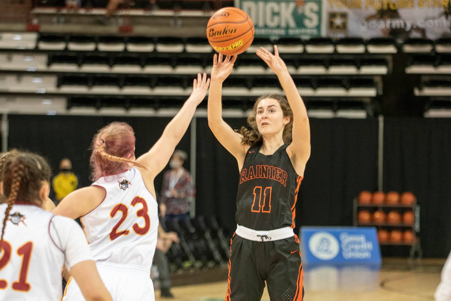 Rainier senior Faith Boesch (11) shoots a 3-pointer during the opening round of the 2B state tournament against Lake Roosevelt on Wednesday at the Spokane Arena.