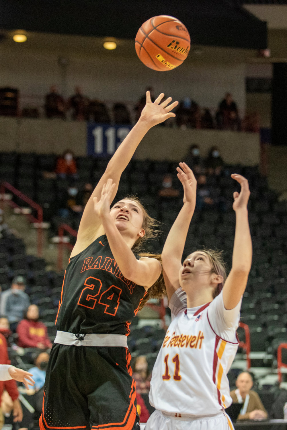 Rainier’s Bryn Beckman (24) throws up a shot in the paint against Lake Roosevelt in the 2B state tournament Wednesday at the Spokane Arena.