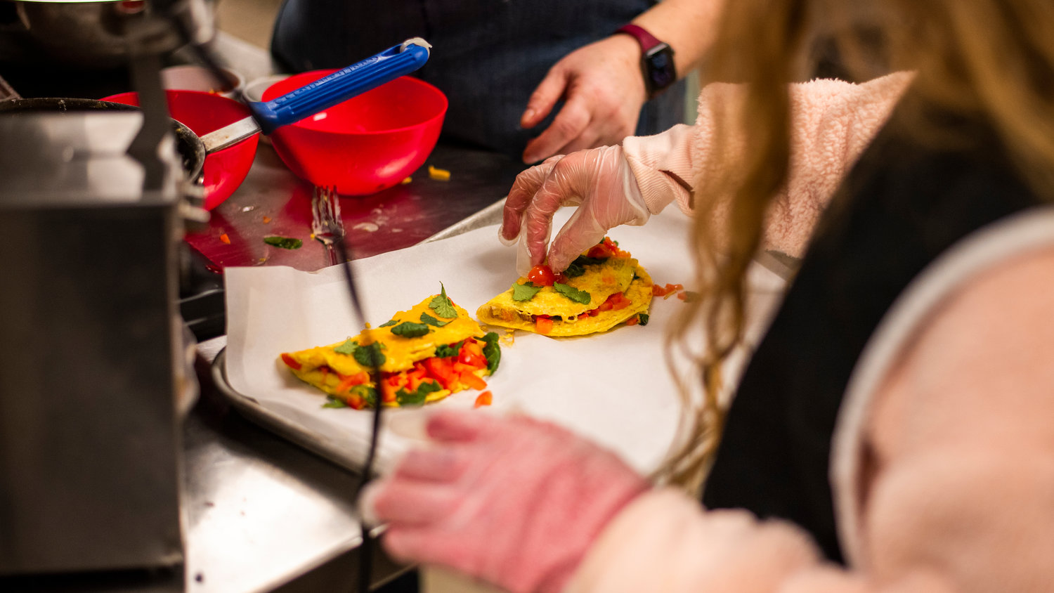 Dishes are prepared by students inside The Cougar Cafe kitchen at Orin C. Smith Elementary in Chehalis on Monday.