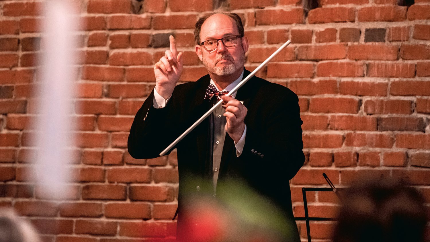 Dr. Douglas Frank uses an aluminum pipe as part of a demonstration while speaking to attendees of the Lincoln Day Dinner at The Loft in Chehalis.