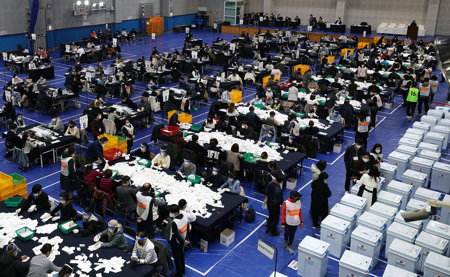South Korean election officials sort voting papers for ballot counting in the presidential election at a gymnasium in Seoul on March 9, 2022. (Hong Yoon-gi/AFP via Getty Images/TNS)