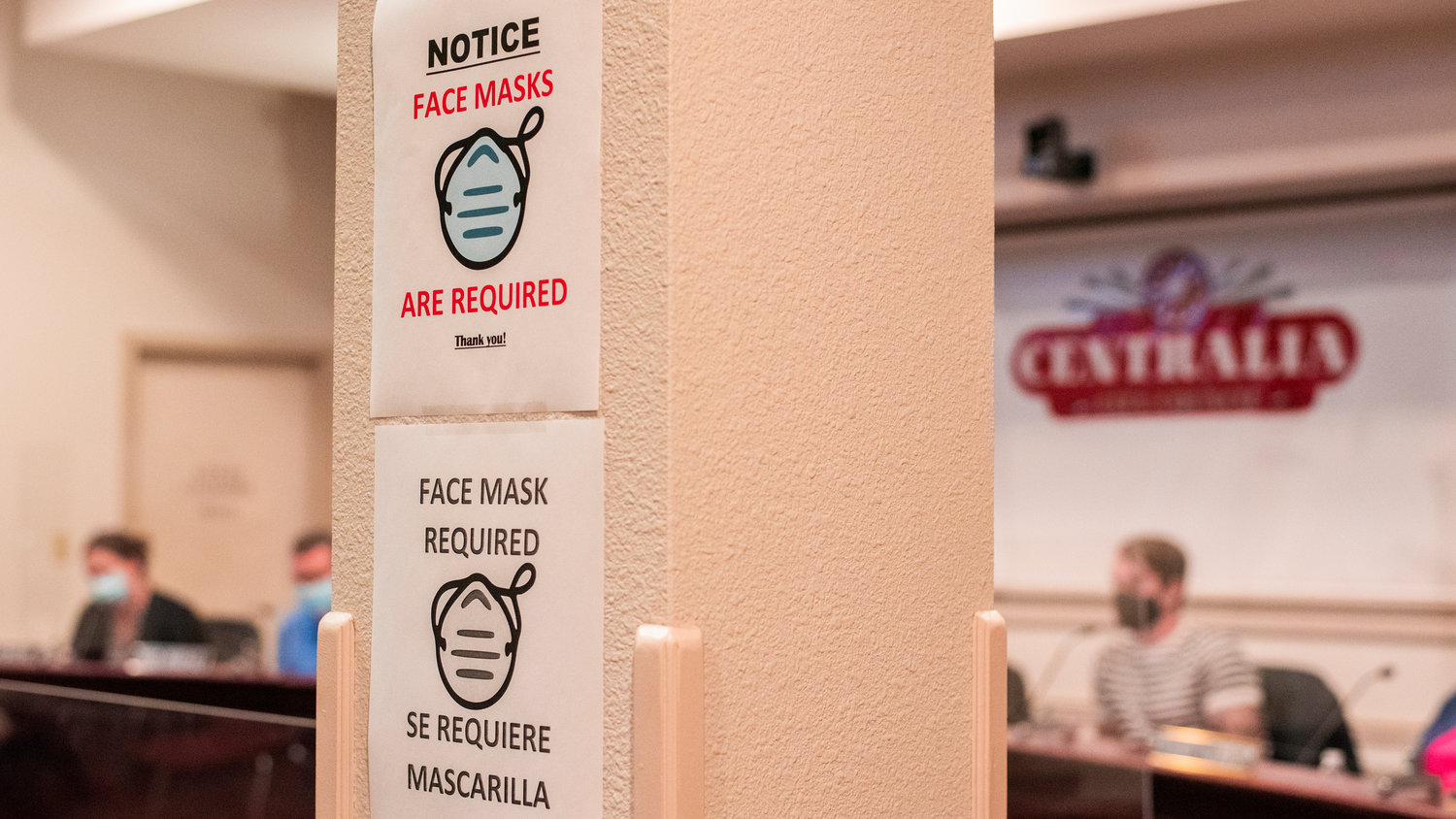 A notice for face masks is displayed inside Centralia City Hall Tuesday night during a meeting.