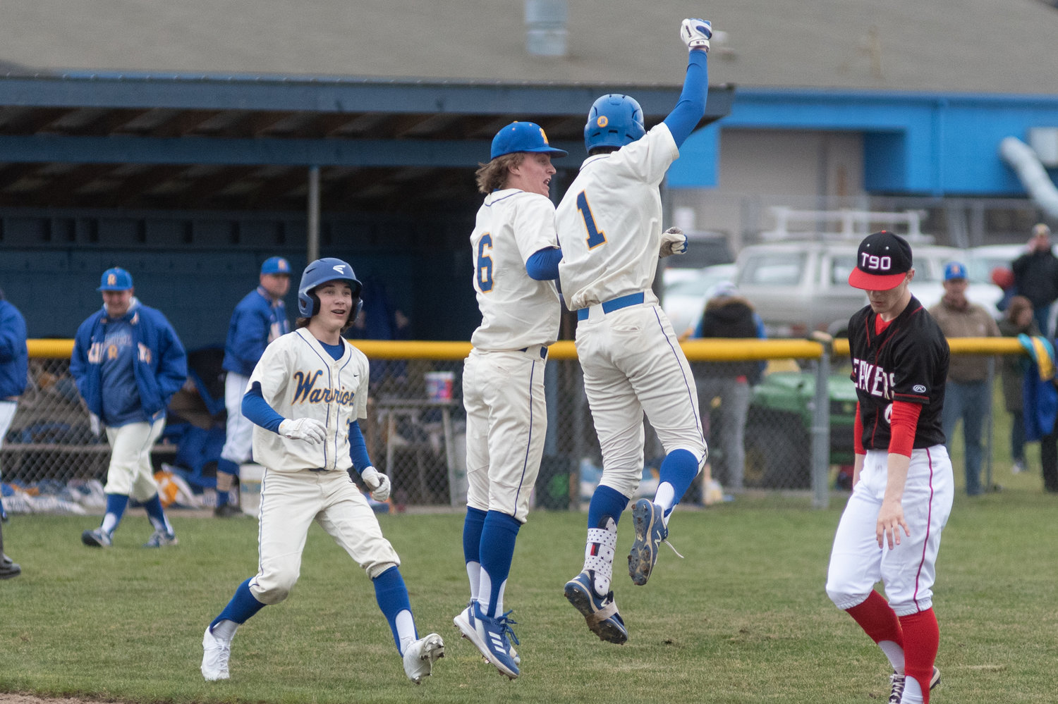 Rochester's Tony Groninger (1) and Landon Hawes (6) celebrate after Groninger's game-winning single in extra innings to beat Tenino in the Scatter Creek Derby March 12.