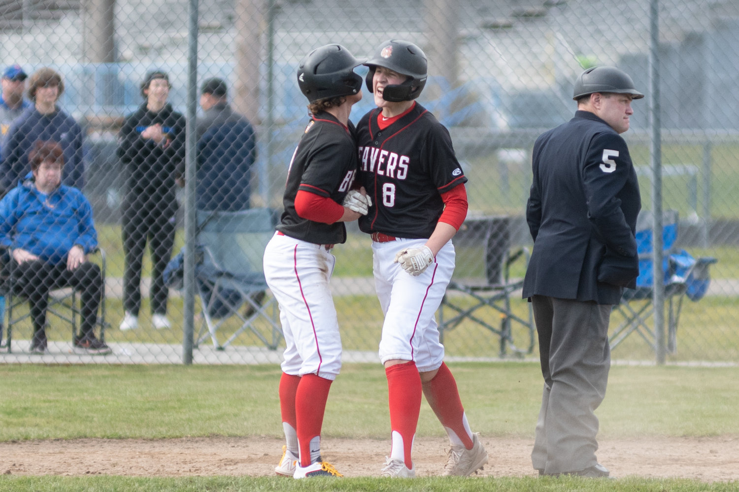 Tenino's Kellan Knox (8) celebrates a run against Rochester in the Scatter Creek Derby March 12.