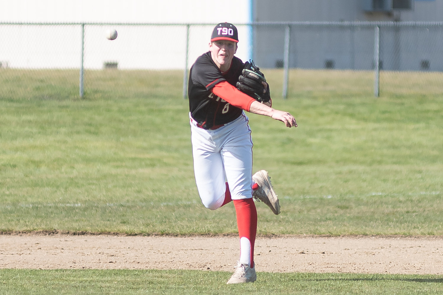 Tenino's Kellan Knox throws towards first base against Rochester in the Scatter Creek Derby March 12.
