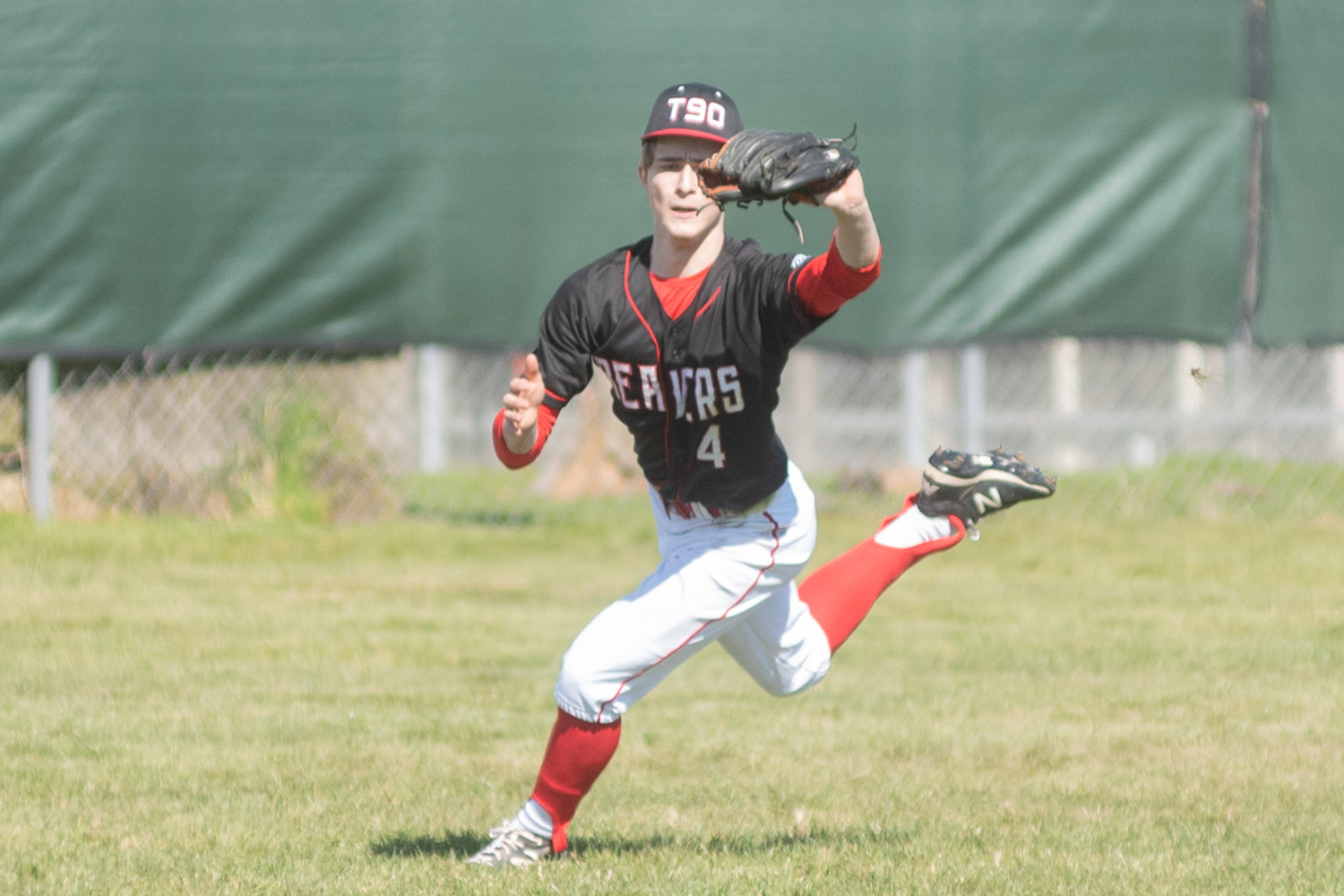 Tenino's Cody Strawn makes a catch in the outfield against Rochester in the Scatter Creek Derby March 12.