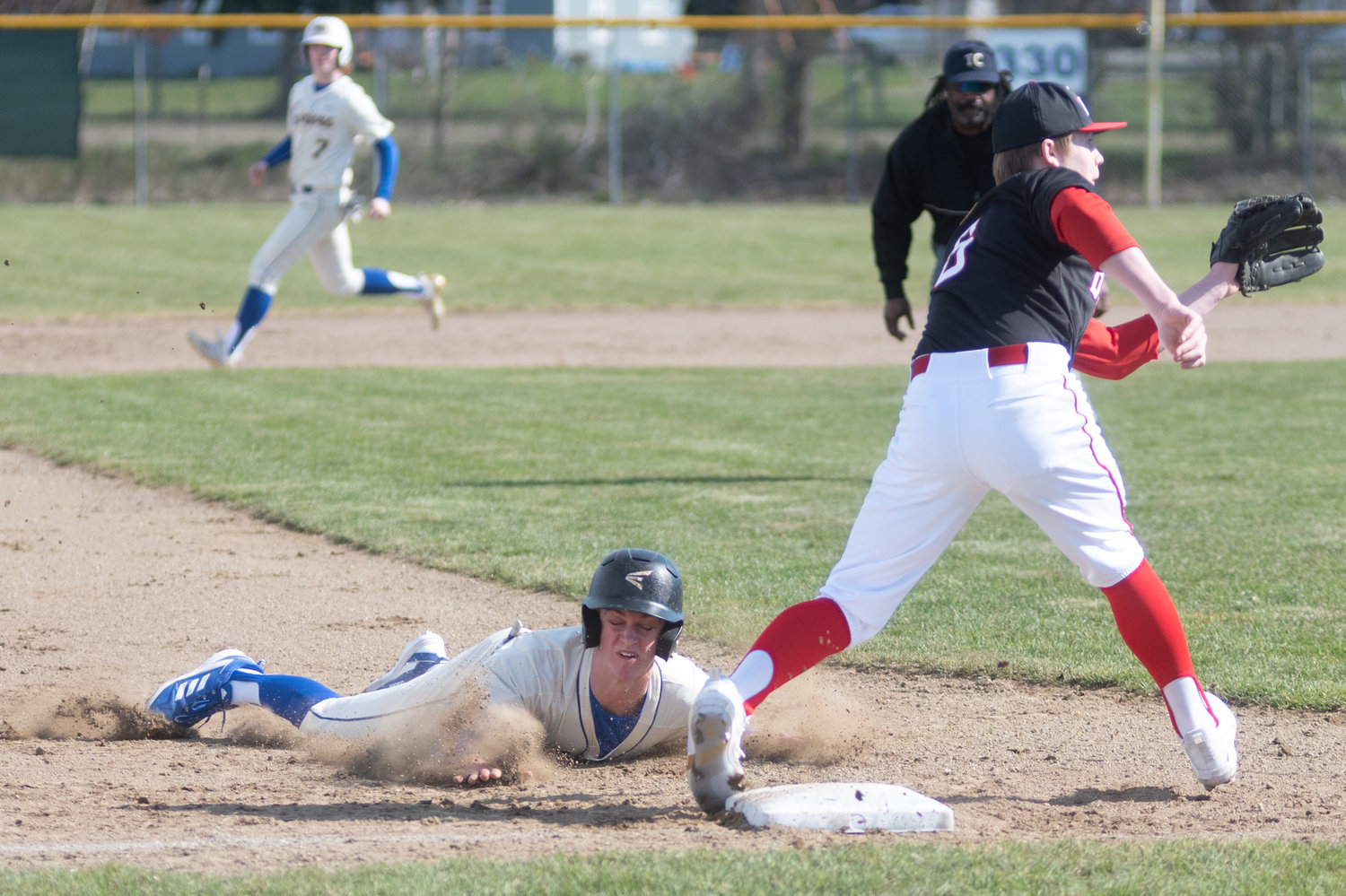 Rochester's Landon Hawes slides for third base against Tenino in the Scatter Creek Derby March 12.