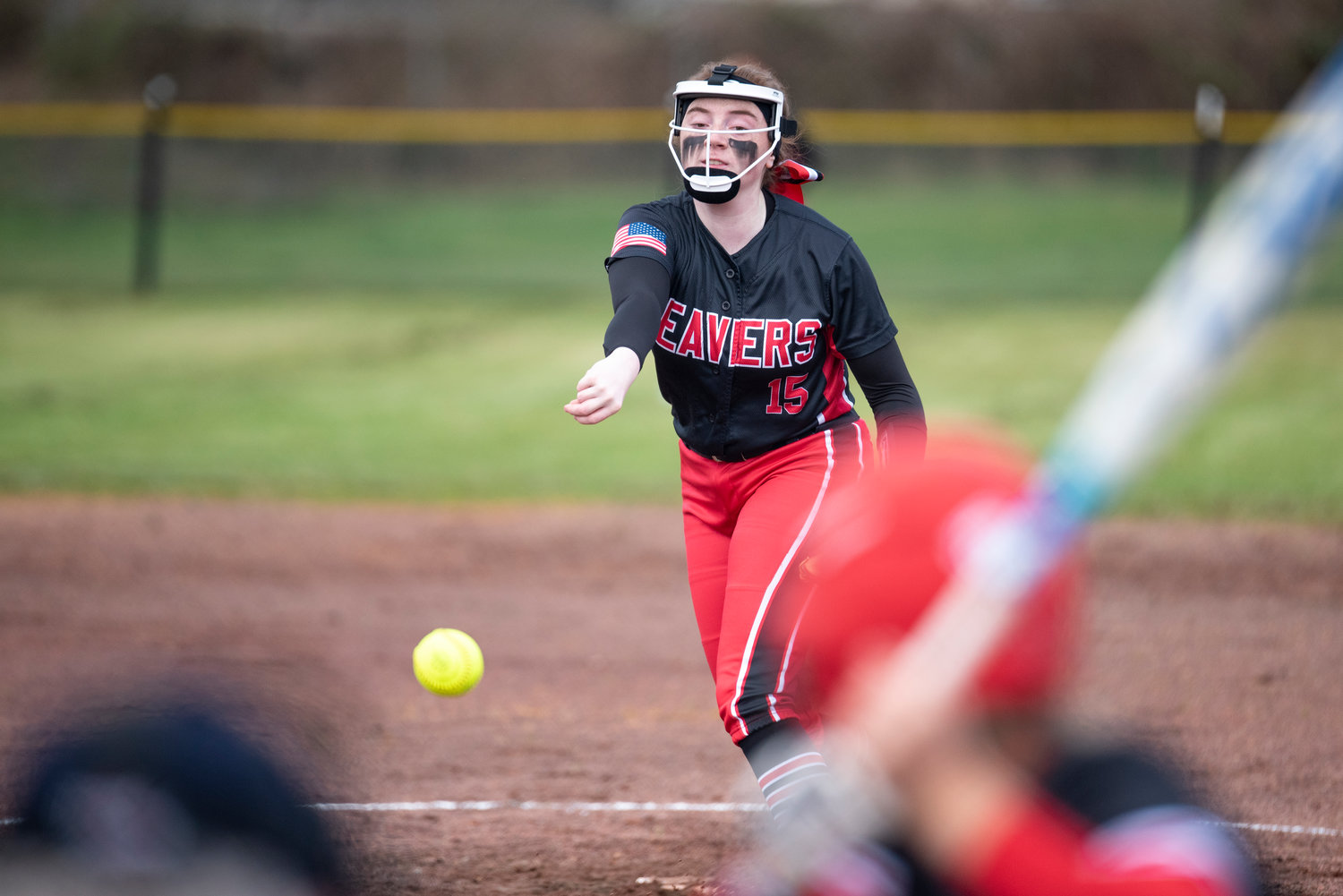 Tenino pitcher Emily Baxter delivers a pitch to Toledo's Brynn Williams during a non-league match at home on March 16.