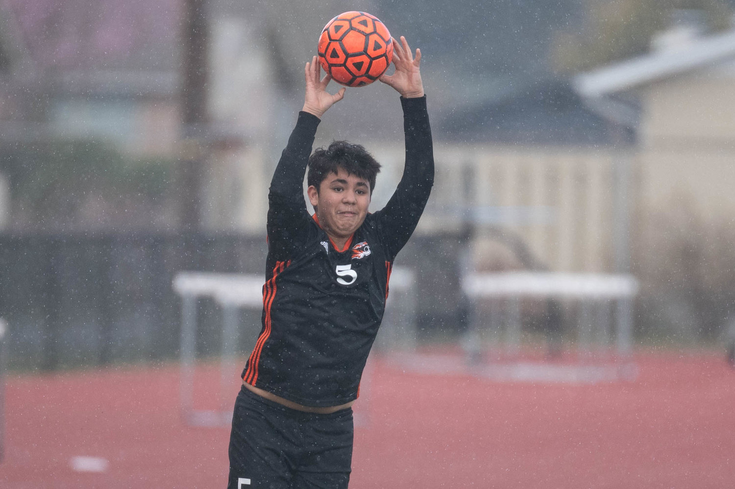 A Centralia player throws the ball in the rain against Tenino March 19 at Tiger Stadium.