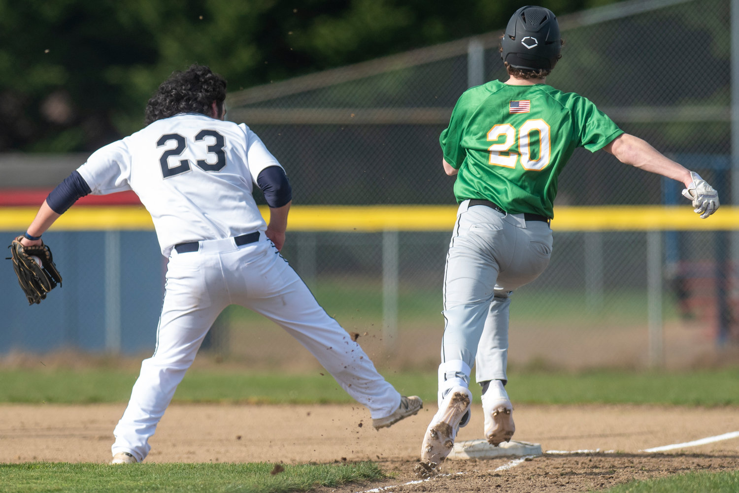 Black Hills pitcher Josephy Floyd (23) tries to beat Tumwater's Derek Thompson (20) to first base on March 24.