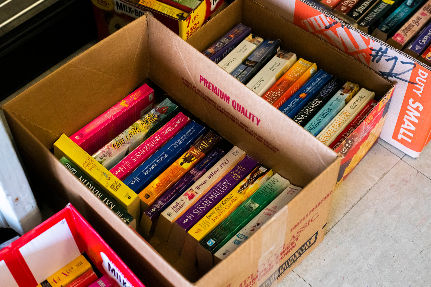 Paperback books sit in boxes inside the Lewis County Mall during the Lewis County AAUW book sale in 2021.