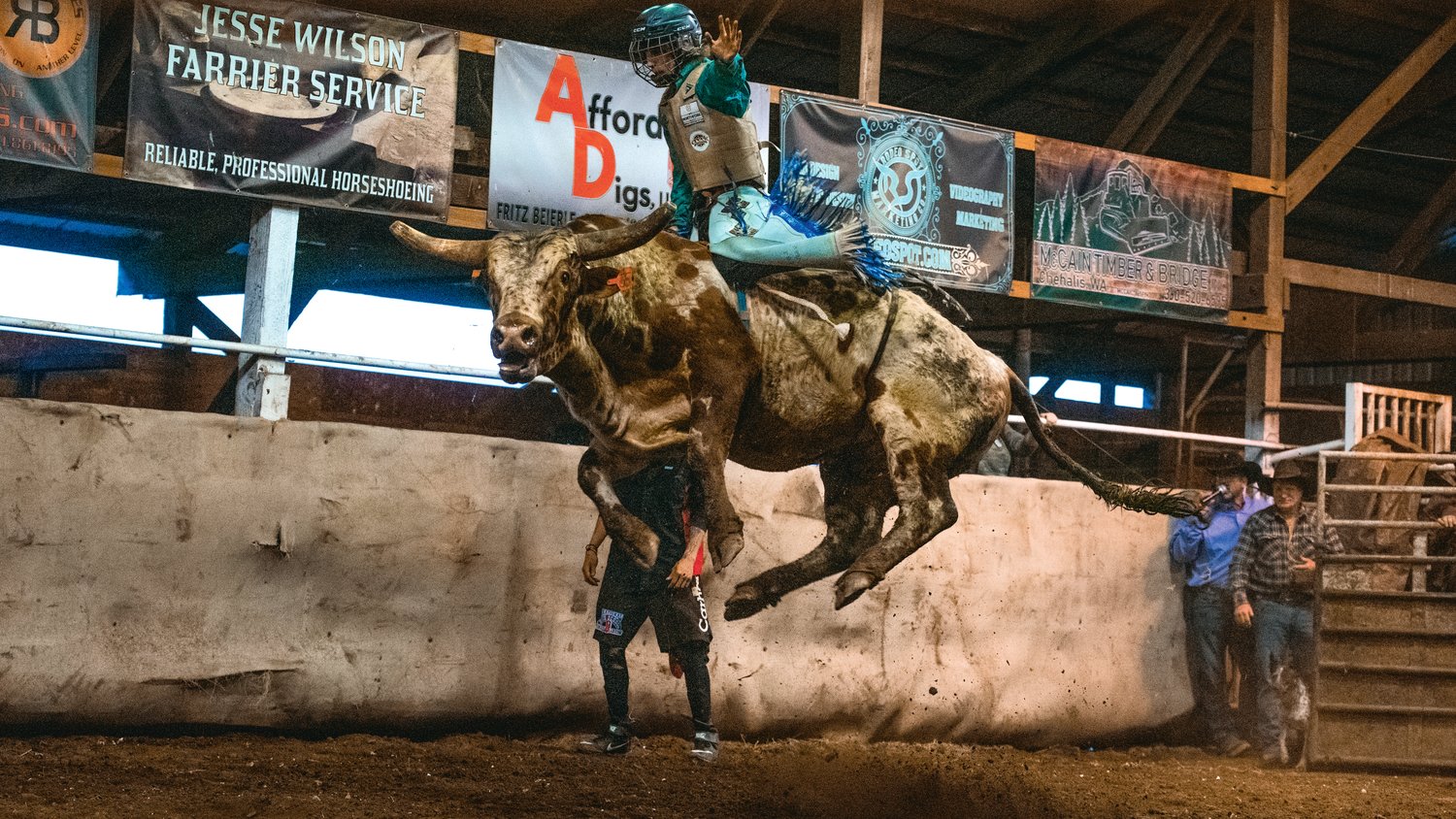 A rider is thrusted into the air by a leaping bull at a Lazy HK Bar Rodeo Winter Series event Saturday in Silver Creek.