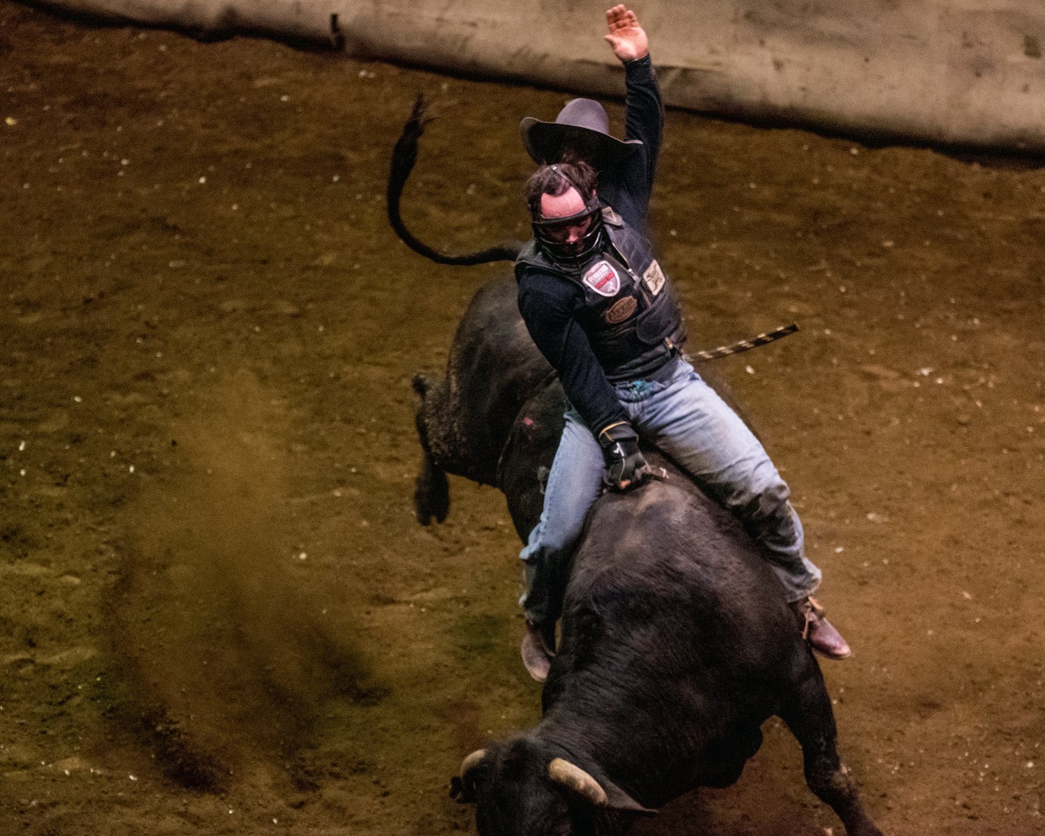 Marc Dorendorf’s hat flies off while riding a bull at a Lazy HK Bar Rodeo Winter Series event Saturday in Silver Creek.