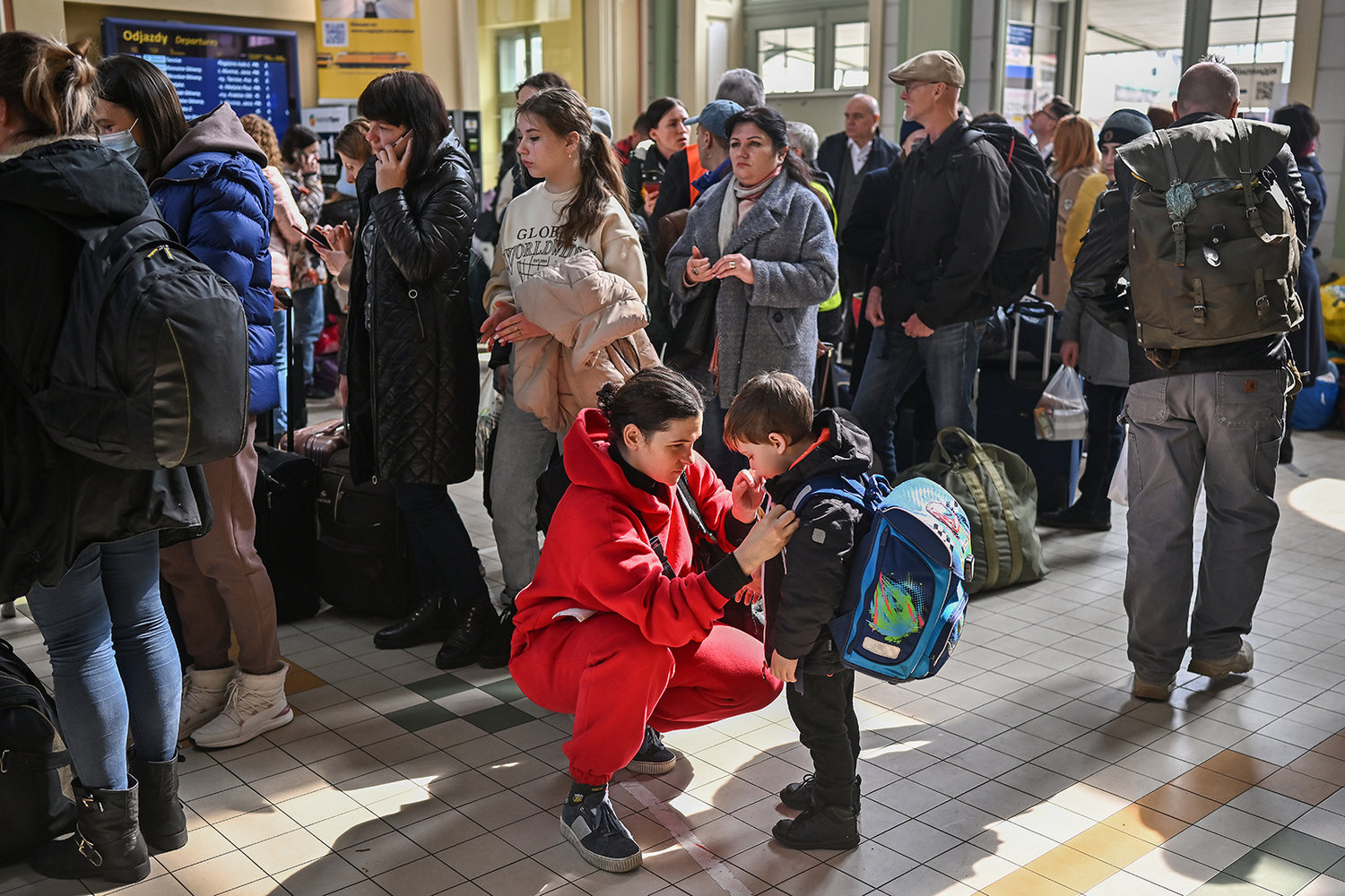 People, mainly women and children, arrive at Przemysl train station after journeying from war-torn Ukraine on March 30, 2022, in Przemysl, Poland. The Polish government has said it may spend €24 billion this year hosting refugees fleeing the war in Ukraine, and is seeking more support from the European Union. With more than 4 million Ukrainian refugees, Poland is now the country with the second-largest foreign refugee population after Turkey. (Jeff J Mitchell/Getty Images/TNS)