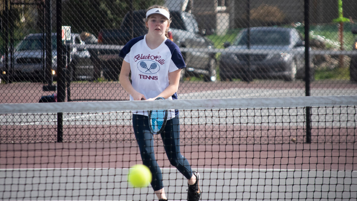 Black Hills’ second doubles player Chloe Whitcraft watches the ball during a match at W.F. West on Wednesday afternoon.