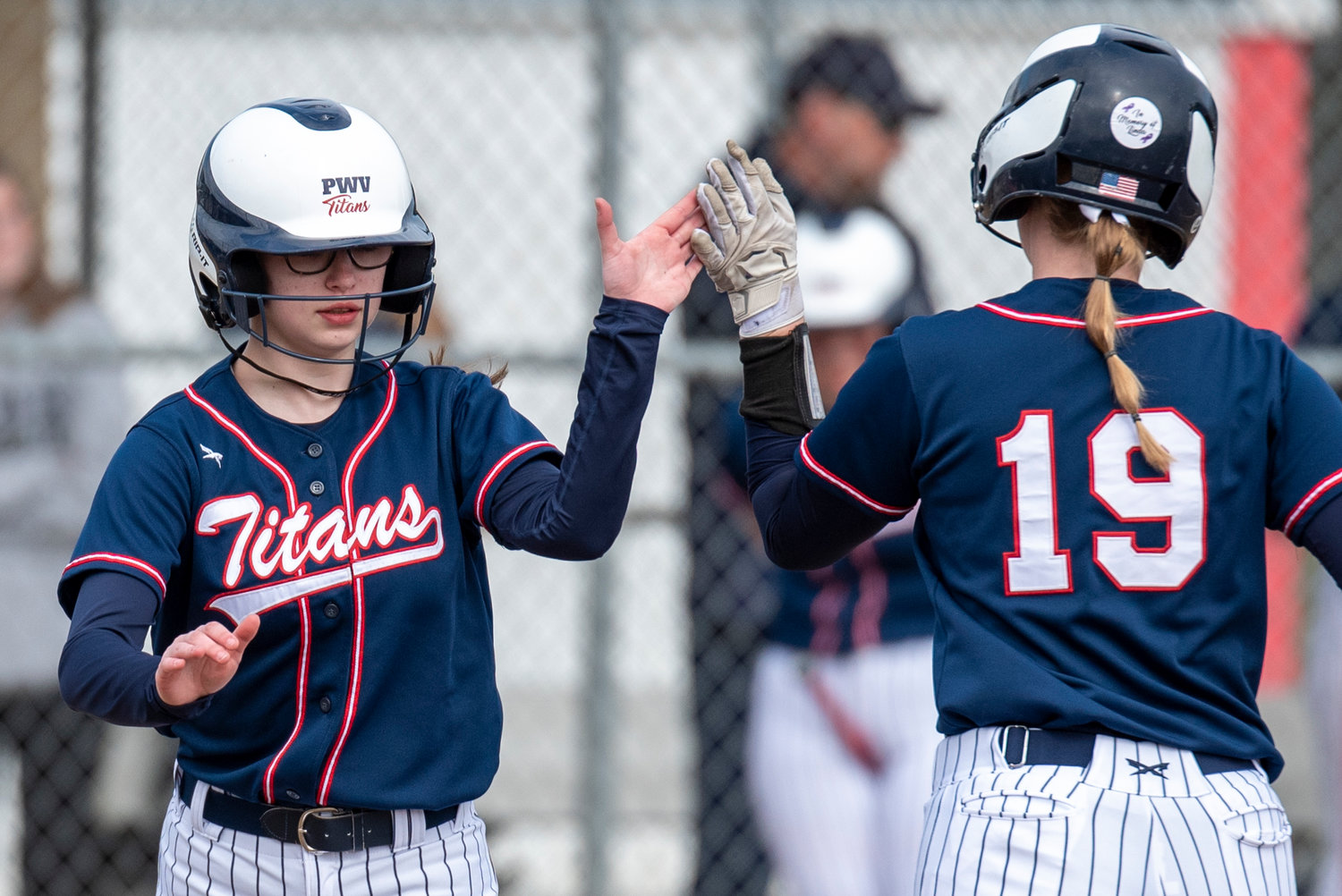 PWV's Lauren Emery, left, and Olivia Matlock (19) high-five as Emery pinch-runs for Matlock during a home game against Forks on April 1.
