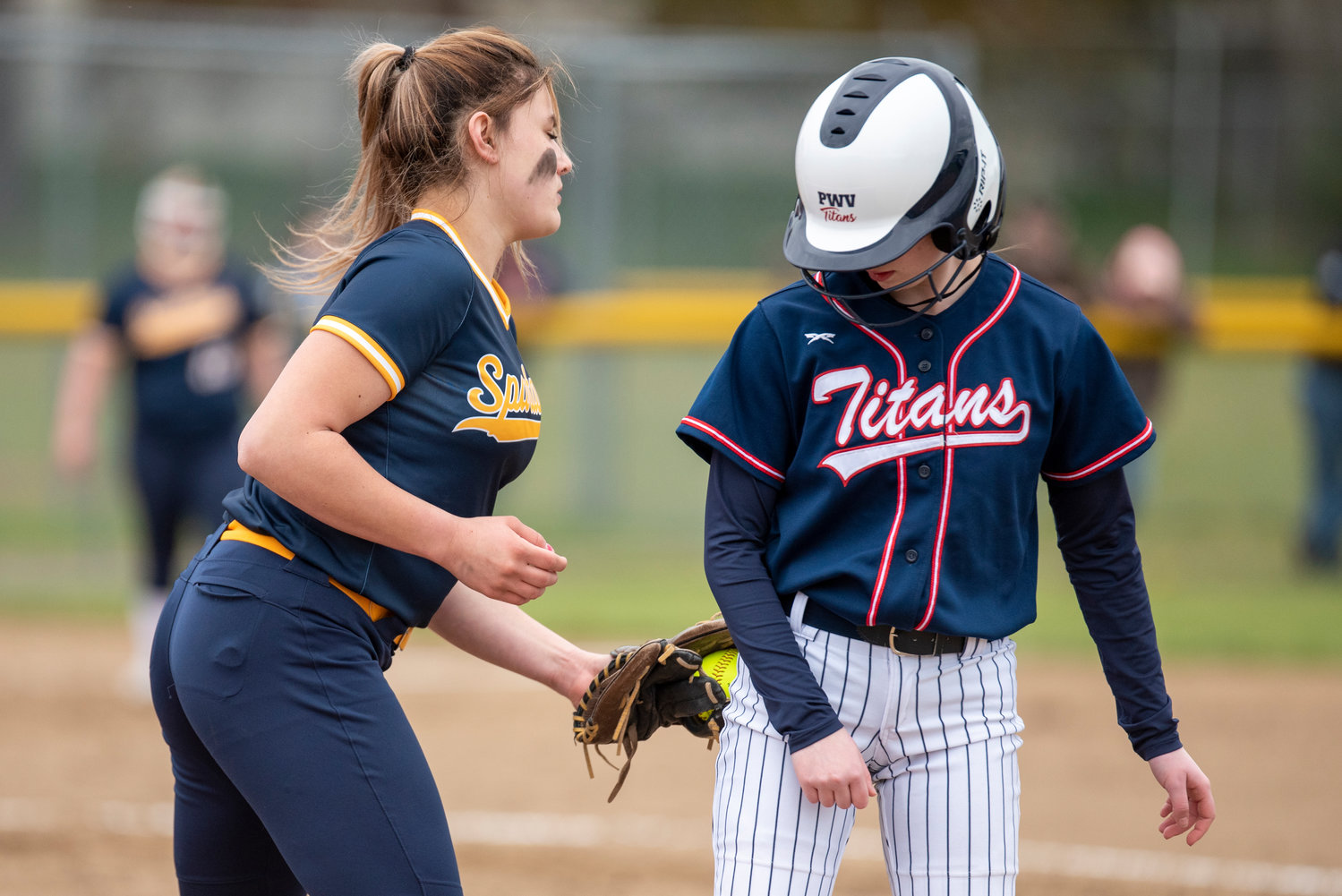 PWV's Lauren Emery, right, gets back to first base safely before a Forks tag during a home game on April 1.