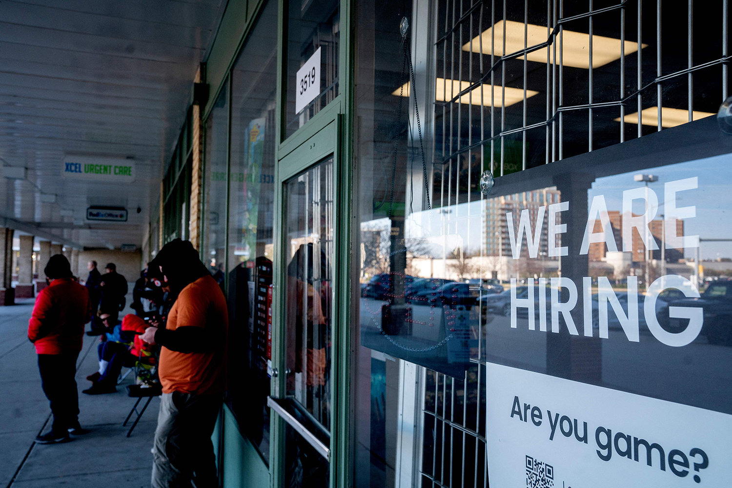 A "We Are Hiring" sign is displayed at a Game Stop in Baileys Crossroads, Virginia, on April 2, 2022. (Stefani Reynolds/AFP via Getty Images/TNS)
