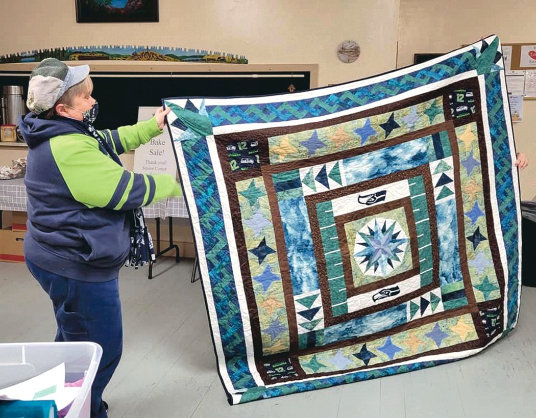 A quilt crafted by members of the Prairie Points Quilt Guild is pictured.