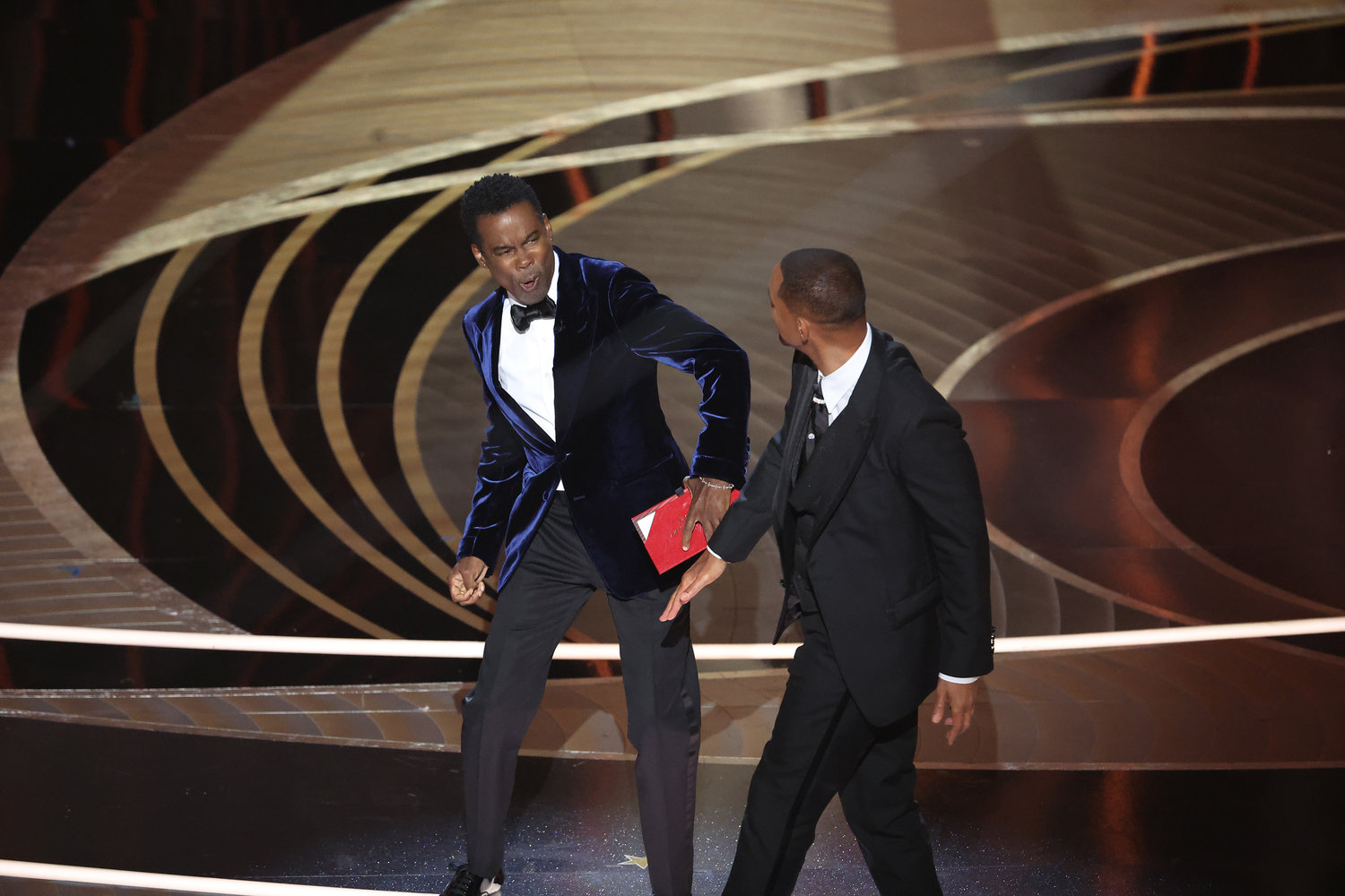 Chris Rock, left, and Will Smith onstage during the 94th Academy Awards at the Dolby Theatre on March 27, 2022, in Hollywood, California. (Myung Chun/Los Angeles Times/TNS)