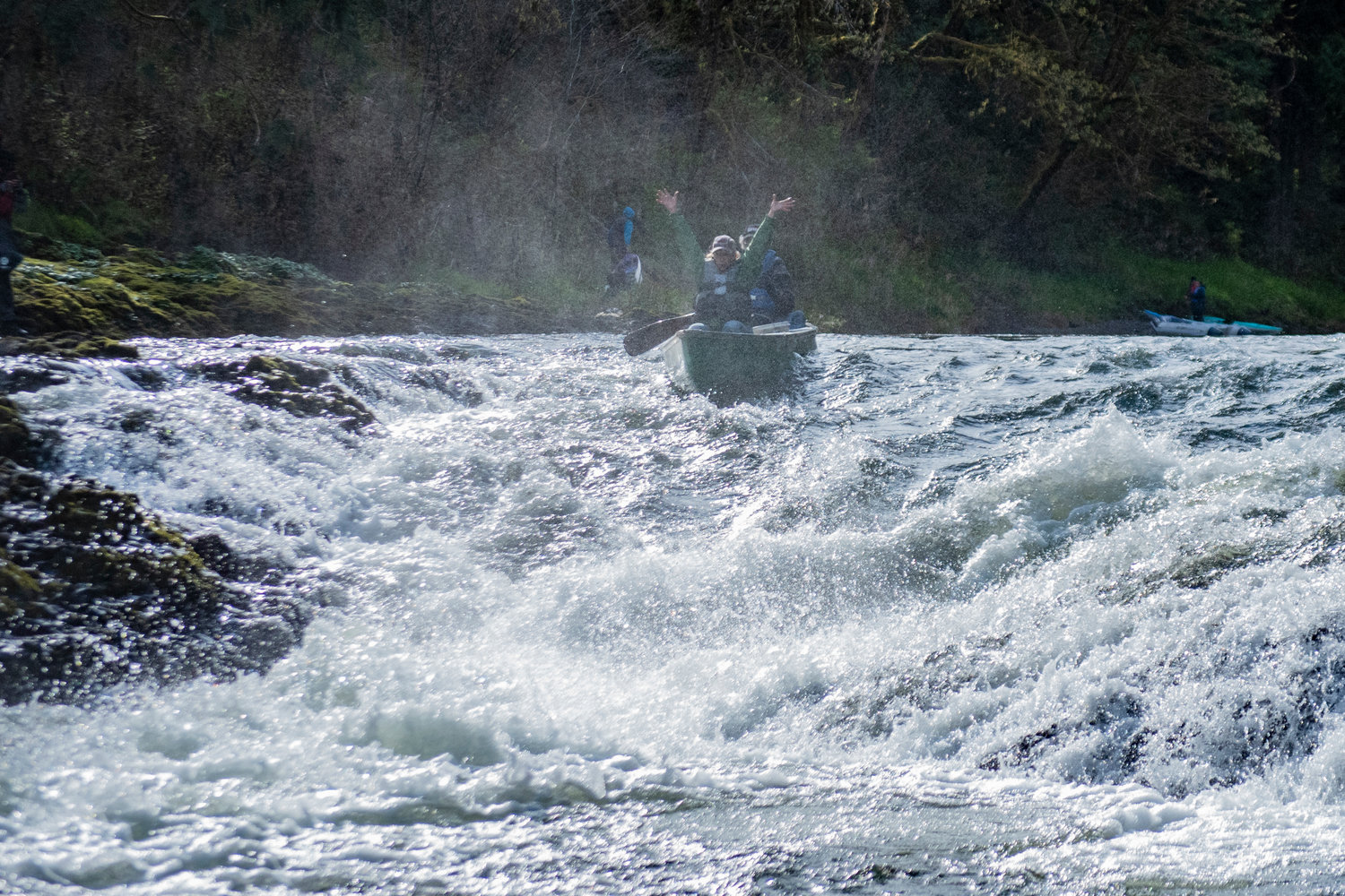 Two people in a canoe ride through the spray at Rainbow Falls during the Pe Ell River Run on Saturday.
