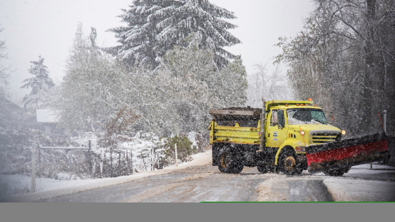 A snow plow travels down Rice Road after moving slush off a portion of the roadway in Chehalis Monday morning.