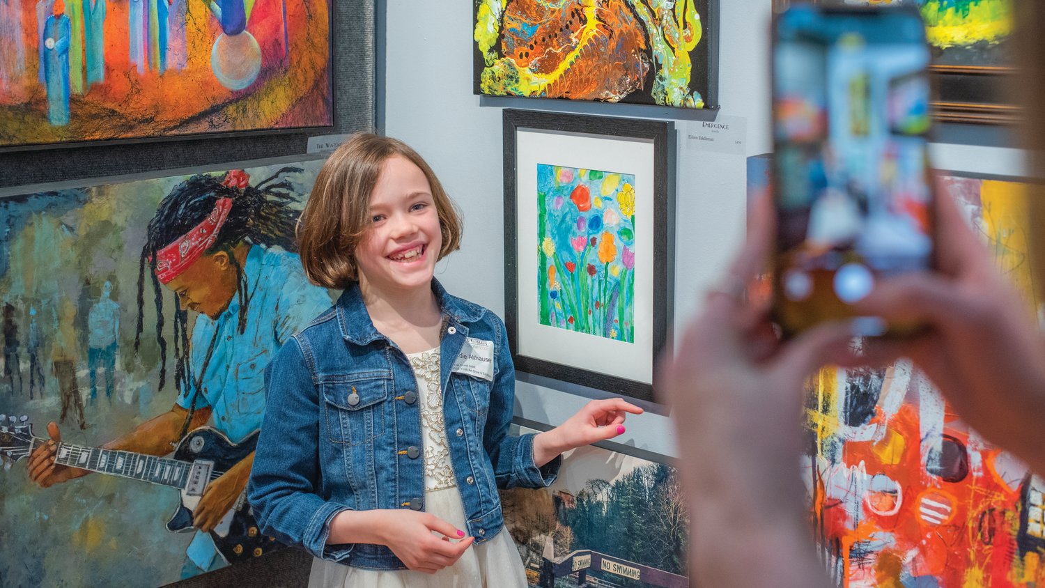 Haddie Althauser smiles and points to her art Friday in Centralia.