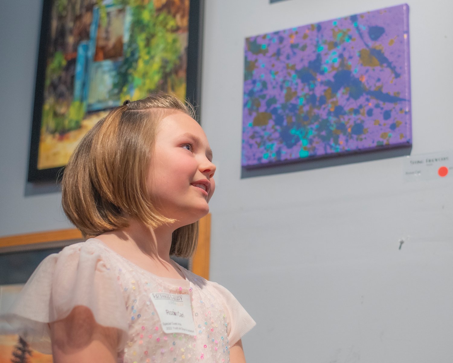 Rozlin Cari, 7, talks about her acrylic creation after it sold Friday at the Rectangle Gallery & Creative Space in Centralia.