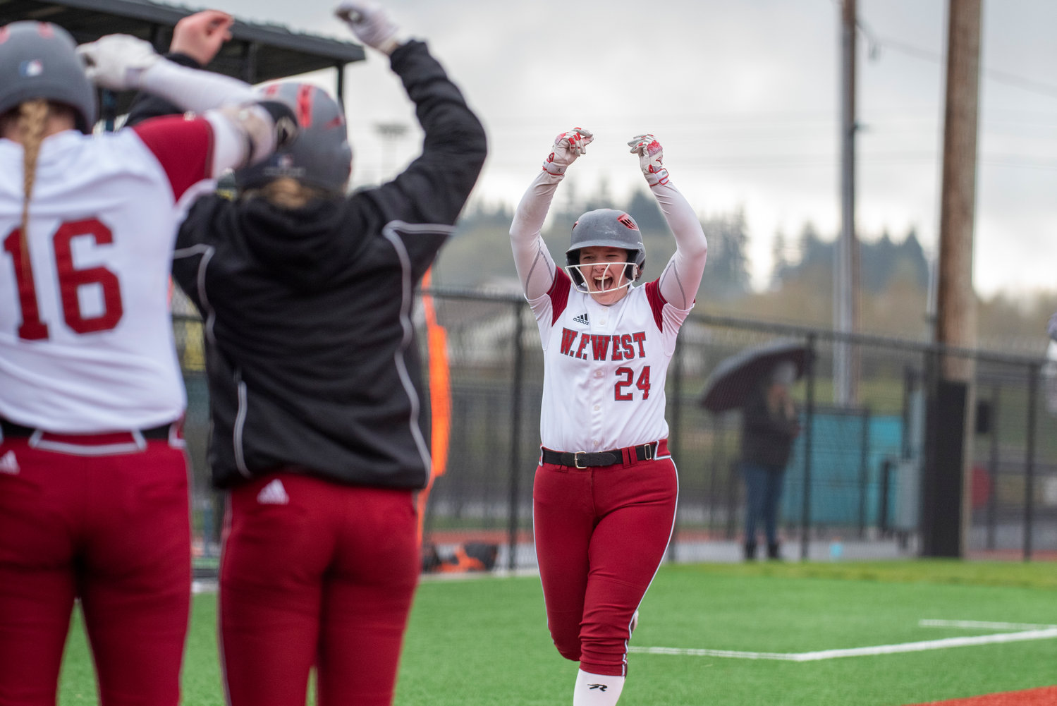 W.F. West's Savannah Hawkins throws her hand up in celebration as she's met at home plate after hitting a three-run homer against Rochester at home on Wednesday, April 13.