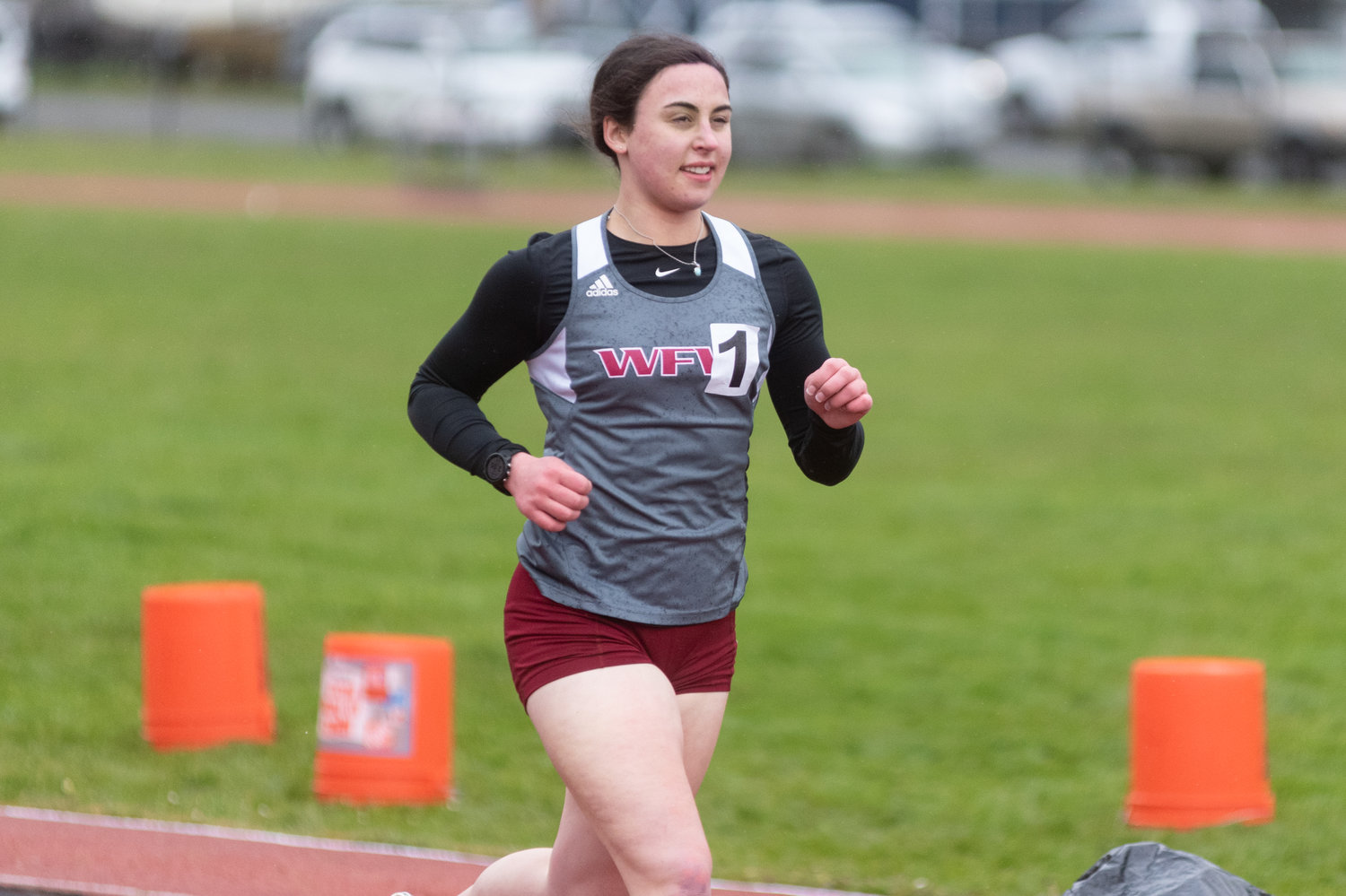 W.F. West's Elaina Koenig smiles while running the 1600m at W.F. West April 13.