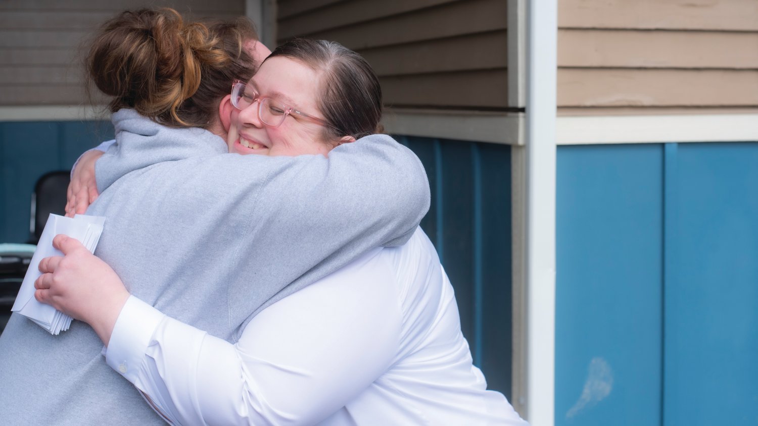 Gin Pack with The Salvation Army receives an embrace from a resident at the Chehalis Avenue Apartments Wednesday while helping to move items back into rooms after buildings were evacuated due to flooding last January.