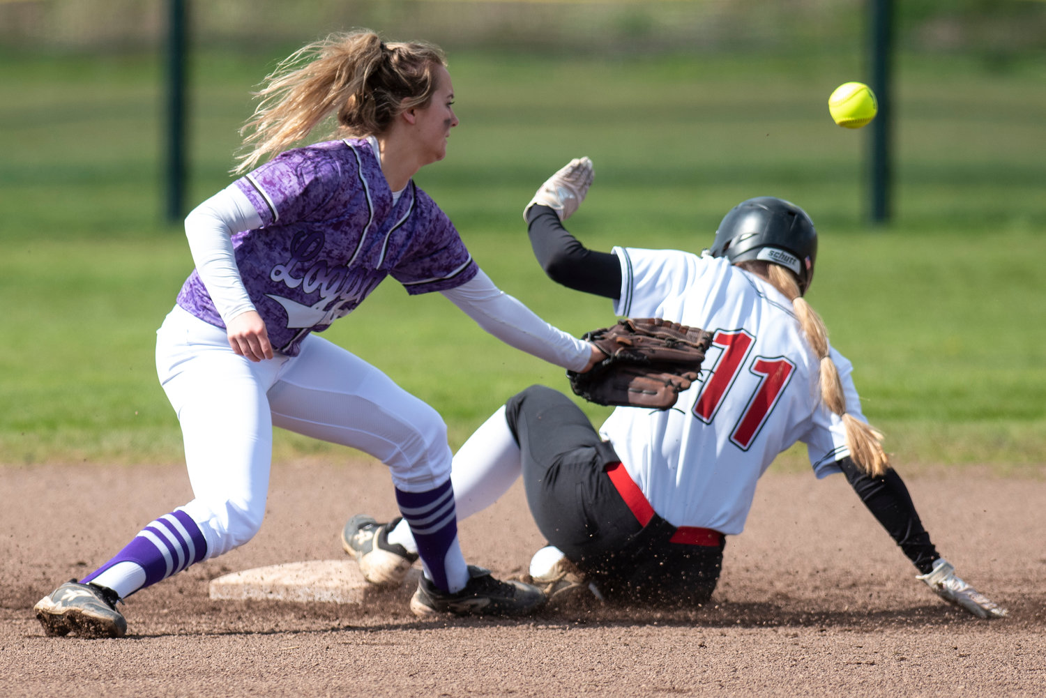 Mossyrock's Hailey Brooks (11) slides safely into second base as Onalaska shortstop Callie Lawrence tries to corral the throw in during a game on April 15.