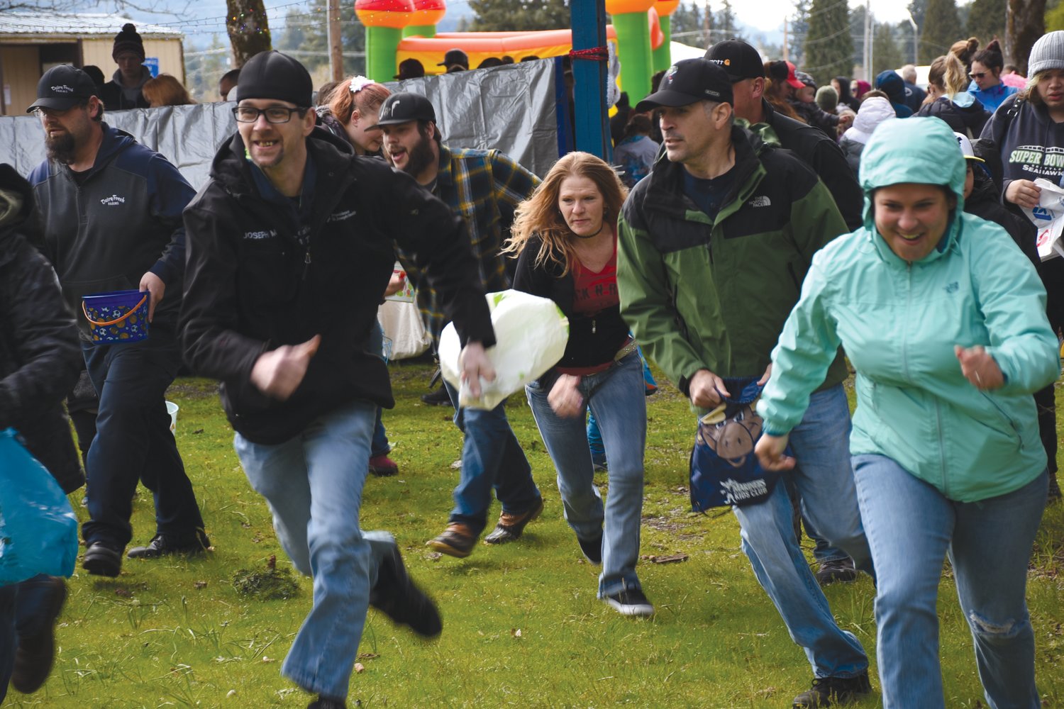 Rainier-area residents compete in a special adult Easter egg hunt on Saturday at Wilkowski Park.