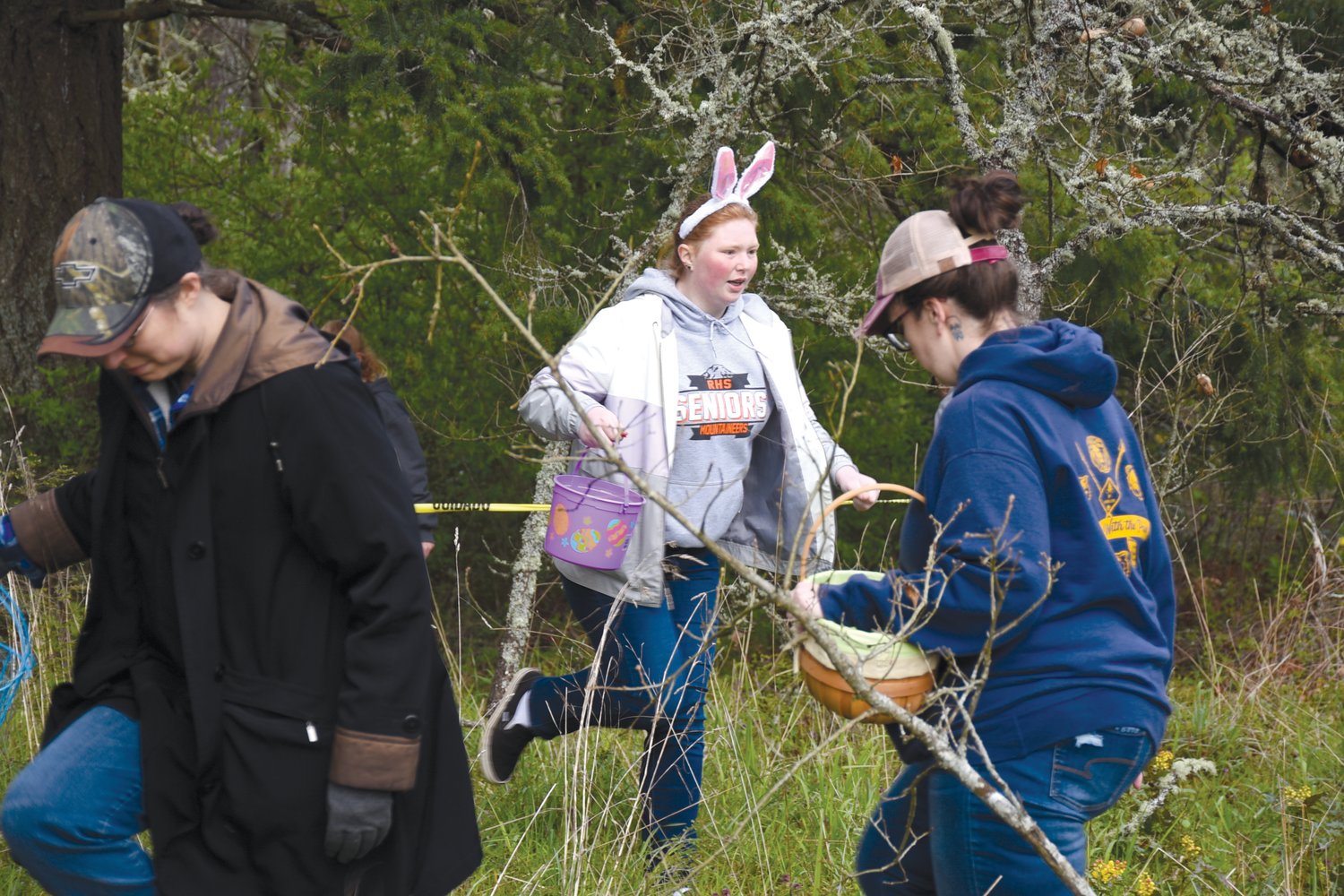 Adults scramble for eggs filled with candy and prizes in a hunt just for them on Saturday at Wilkowski Park in Rainier.