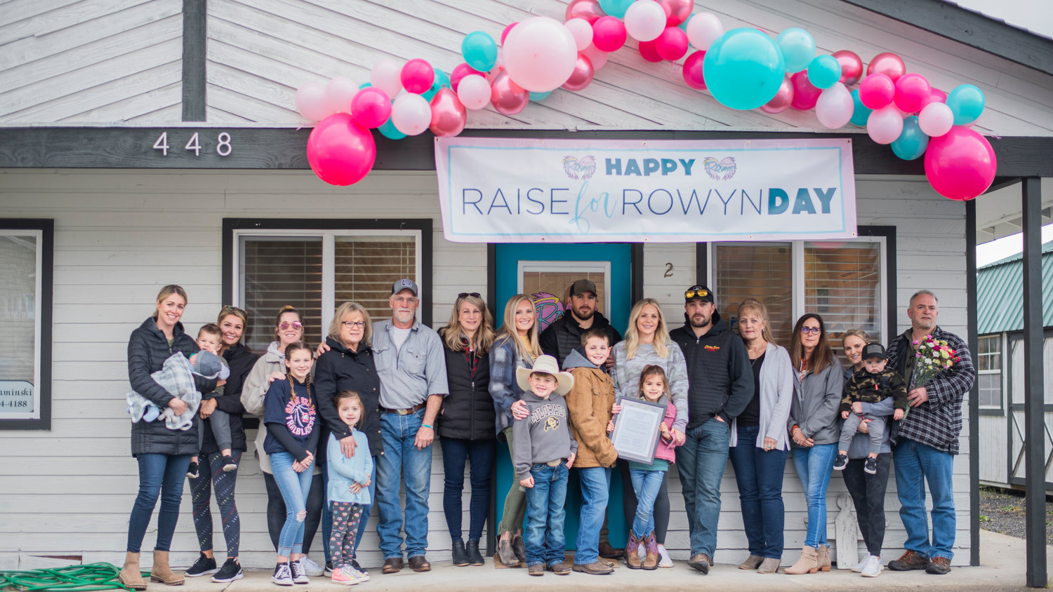Family members pose for a photo Tuesday morning during an event to honor Raise for Rowyn Day in Tenino.
