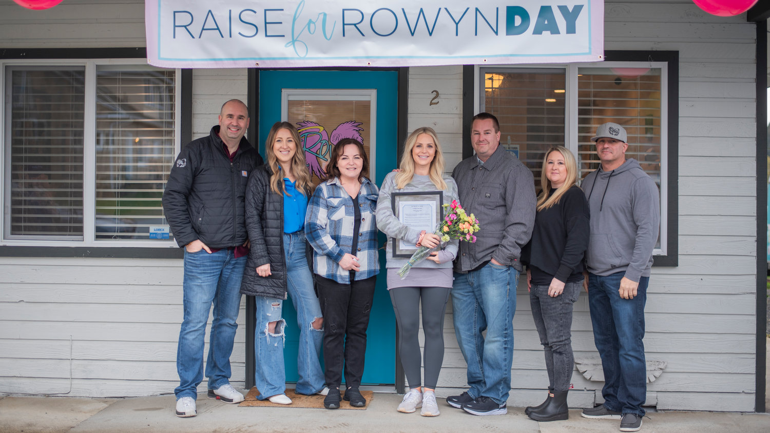 Board members pose for a photo with Brynn Johnson Tuesday during an event honoring Raise for Rowyn Day in Tenino.