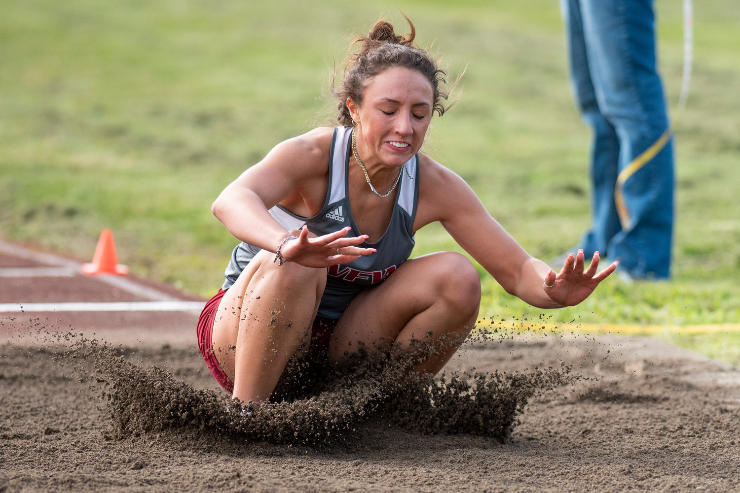 W.F. West's Savanna Bolivar hits the sand pit during the girls long jump at a rivalry meet in Centralia on April 19.