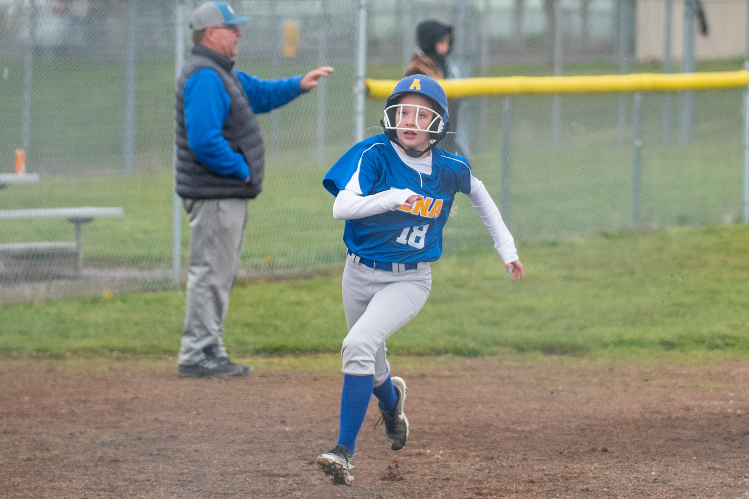 Adna's Lena McCloskey rounds third and races home to score against Winlock during a road game on April 20.