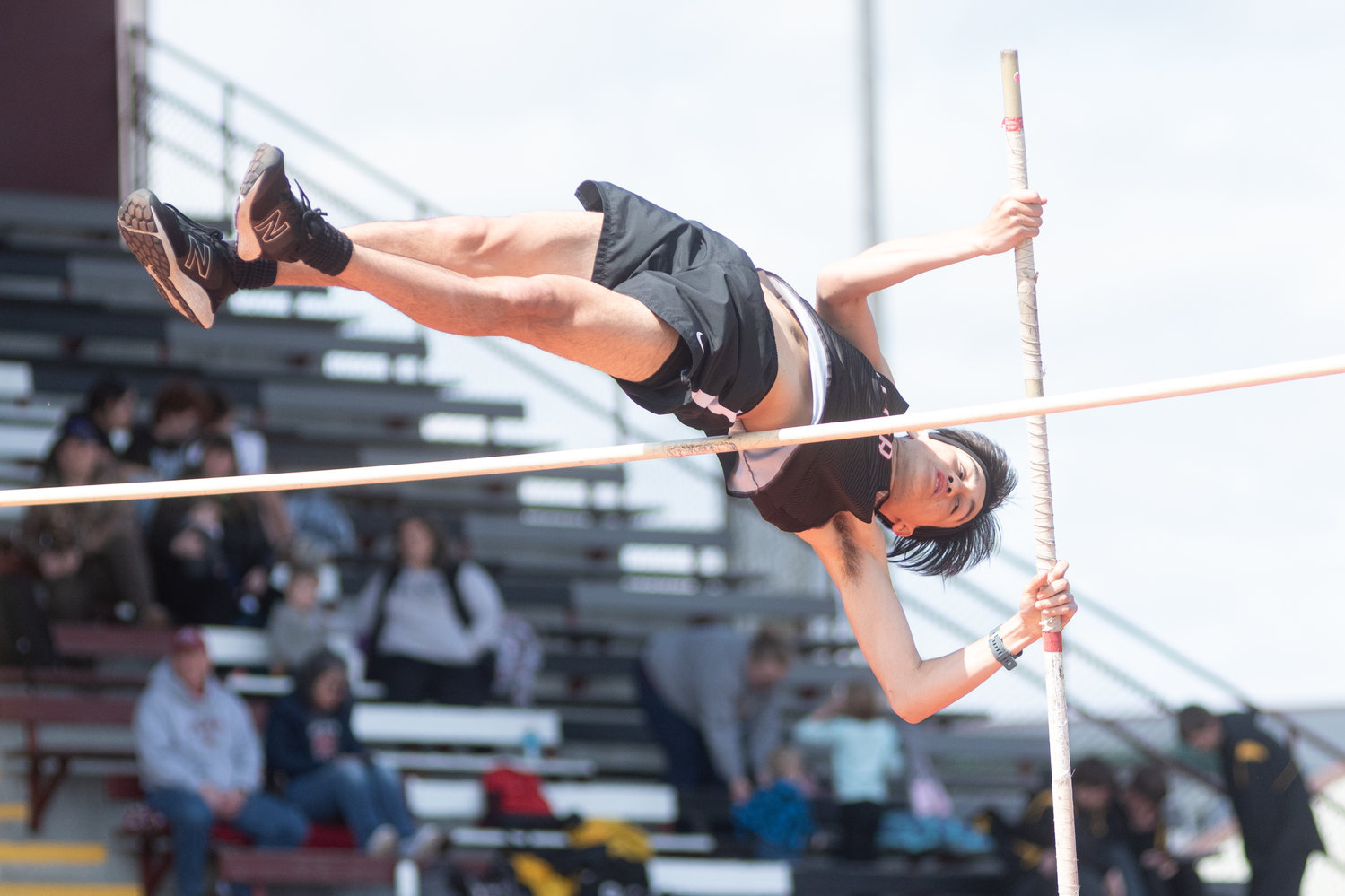 Rainier's Dylan Davis leaps over the bar in the pole vault at the Chehalis Activators Classic at W.F. West April 23.