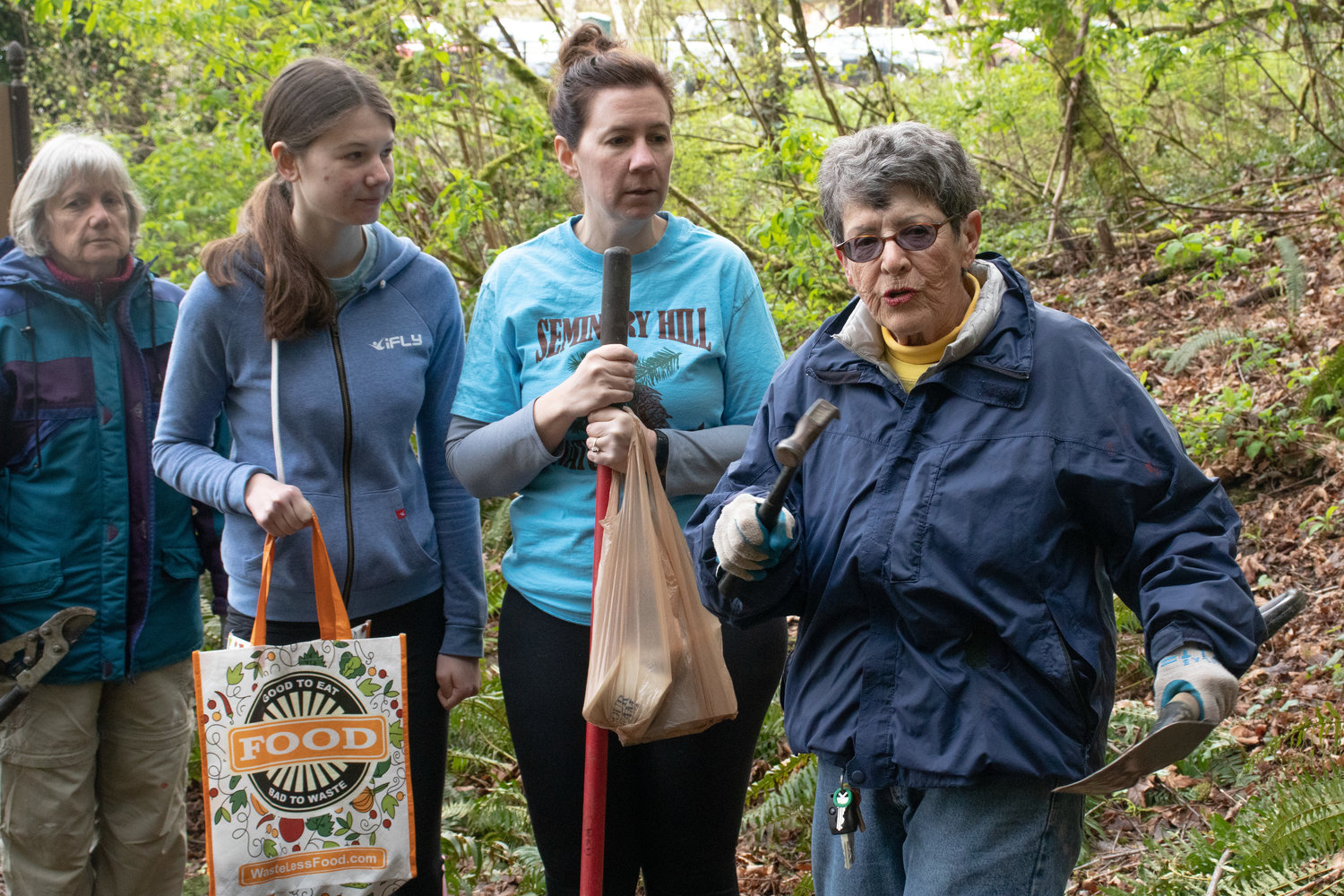 Judi Bell directs volunteers during the Friends of the Seminary Hill Natural Area Earth Day Work Party in Centralia on Saturday.