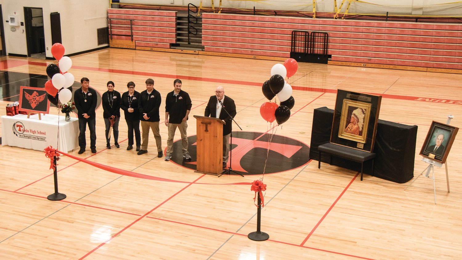 Chris Rust, superintendent of Toledo School District, addresses attendees of a ribbon cutting ceremony inside George Murdock Gymnasium on Friday.