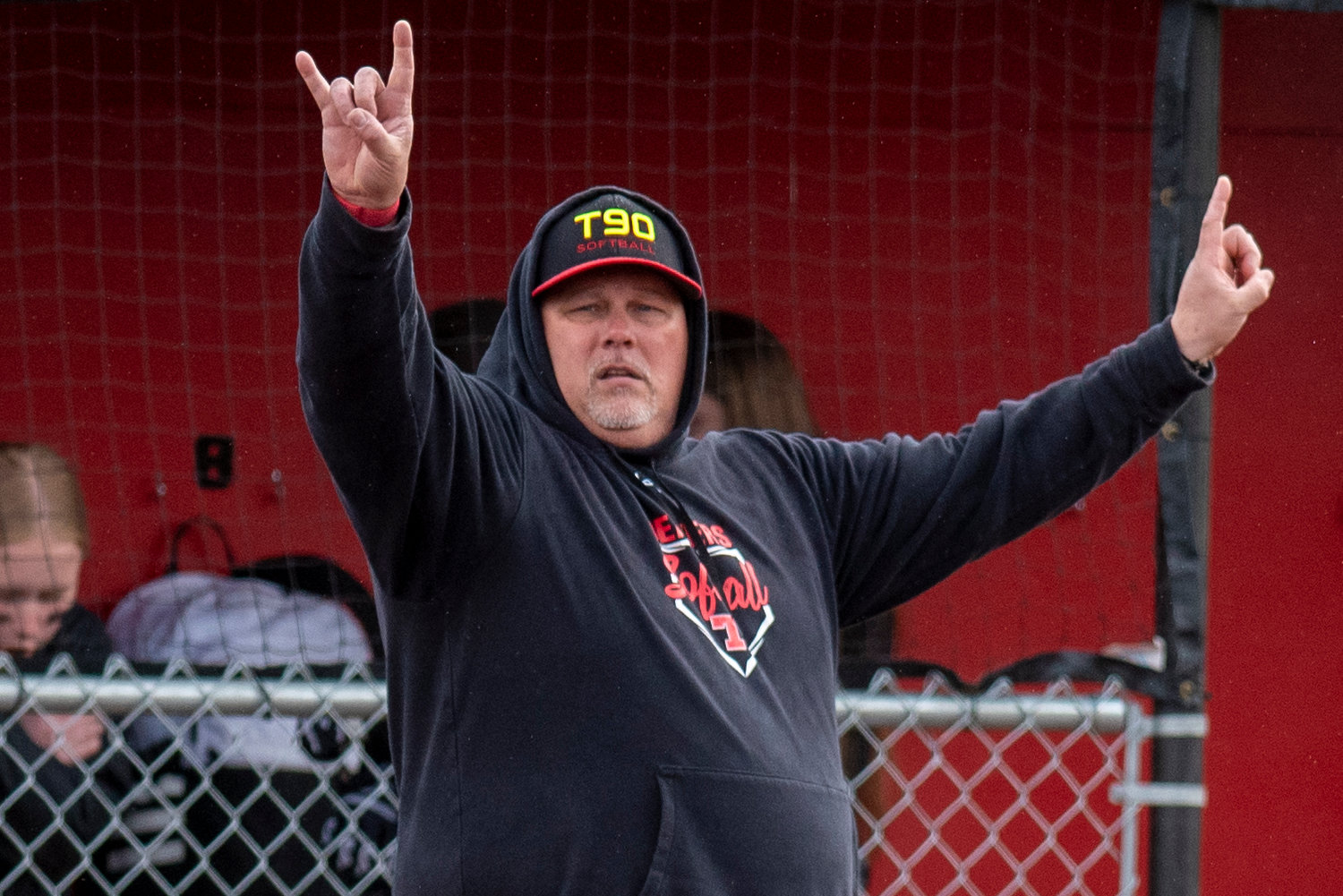 Tenino softball coach Chris Johnson signals two outs to Beaver baserunners during a home game against Elma on April 26, 2022.