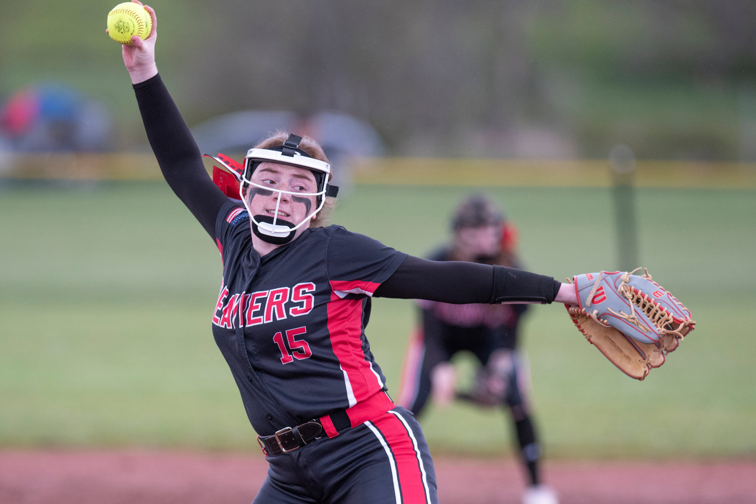 Tenino pitcher Emily Baxter winds up to deliver a pitch to an Elma batter during a league home game on April 26. Baxter was named to The Chronicle's All-Area Team for the 2022 season.