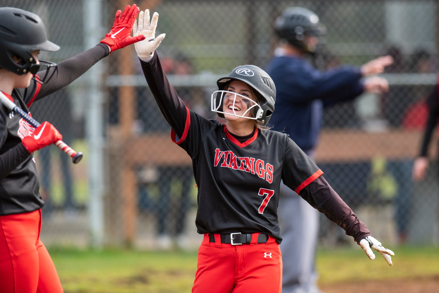 Mossyrock's Lois Stone (7) high-fives a teammate after scoring a run against Oakville during a game at Legends Field Complex in Chehalis Village on April 28.