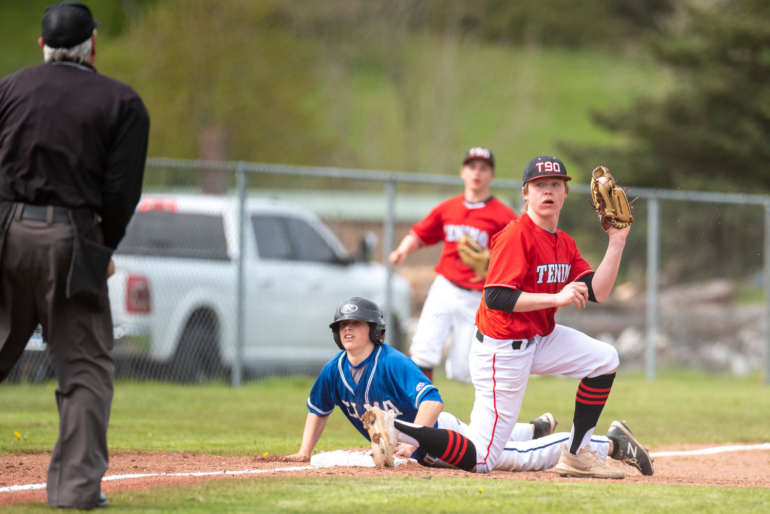 Tenino third baseman Mikey Vassar holds up the ball and looks toward the umpire after tagging an Elma runner out during a home game on April 29.